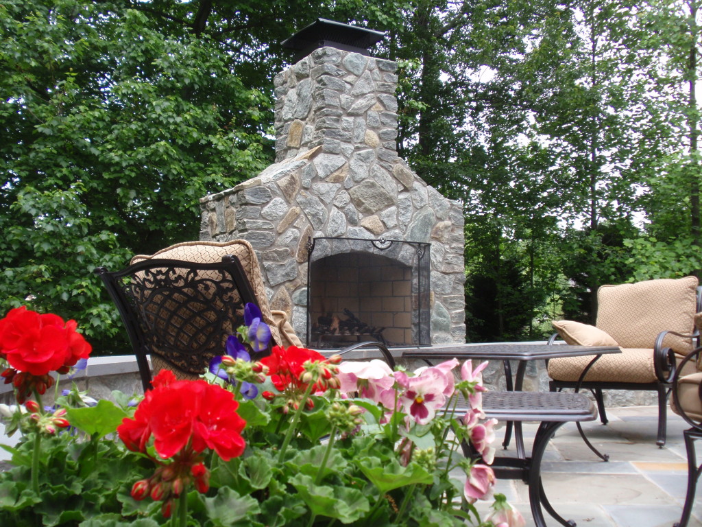 A custom made fireplace will allow you to enjoy your backyard landscape year-long. 